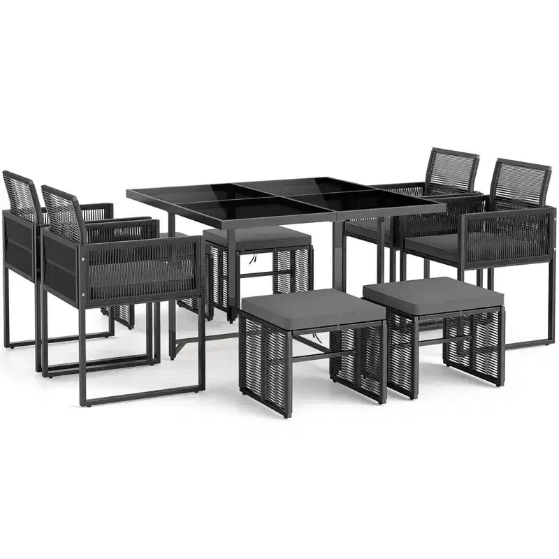 Set da pranzo da patio Costway da 9 pezzi con sedie in rattan PE, tavolo in vetro temperato e pouf