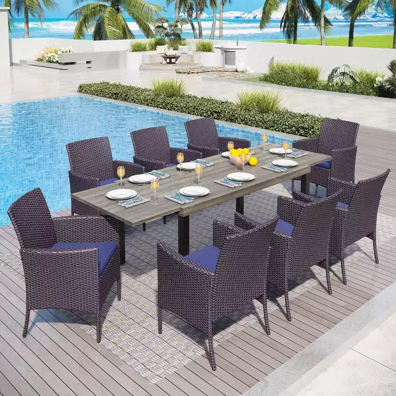 Mesa de comedor extensible de acero para patio exterior Captiva Designs de 9 piezas y sillas de ratán con brazos en forma de media luna